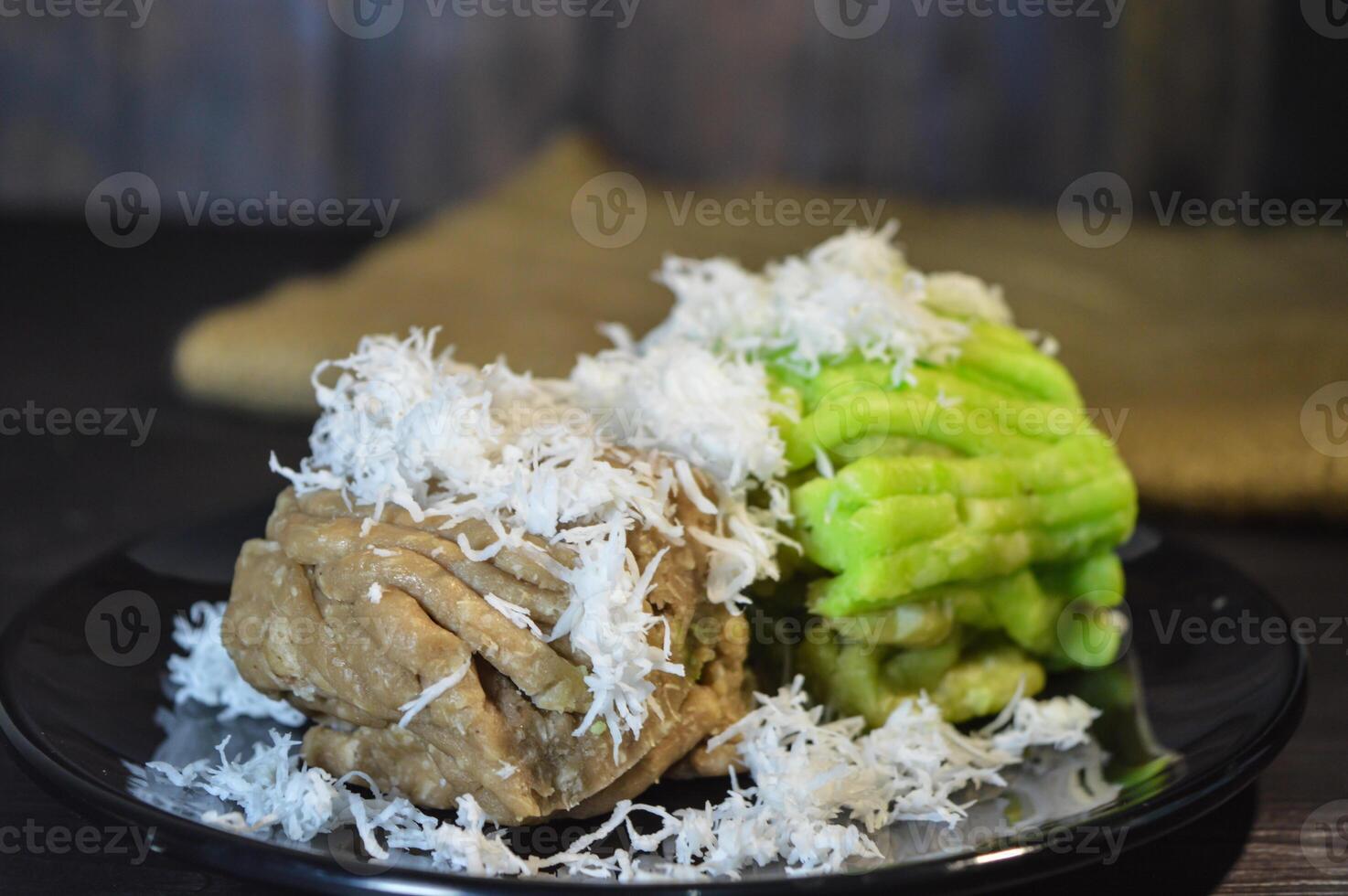 Textured, made from processed cassava that is steamed and mashed. Served with grated coconut. photo