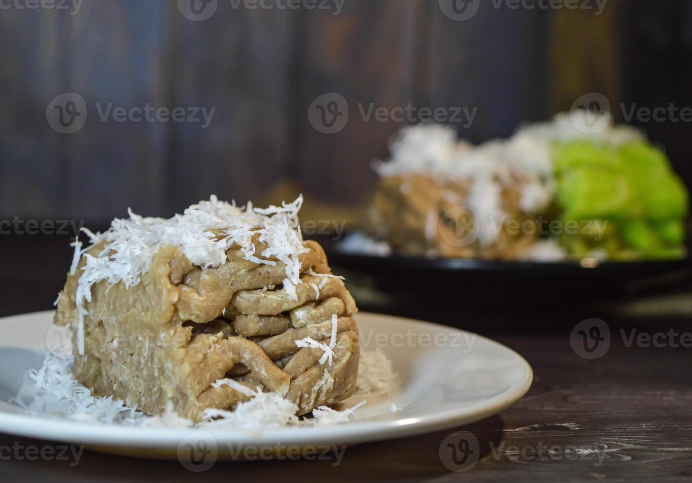 Textured, made from processed cassava that is steamed and mashed. Served with grated coconut. photo