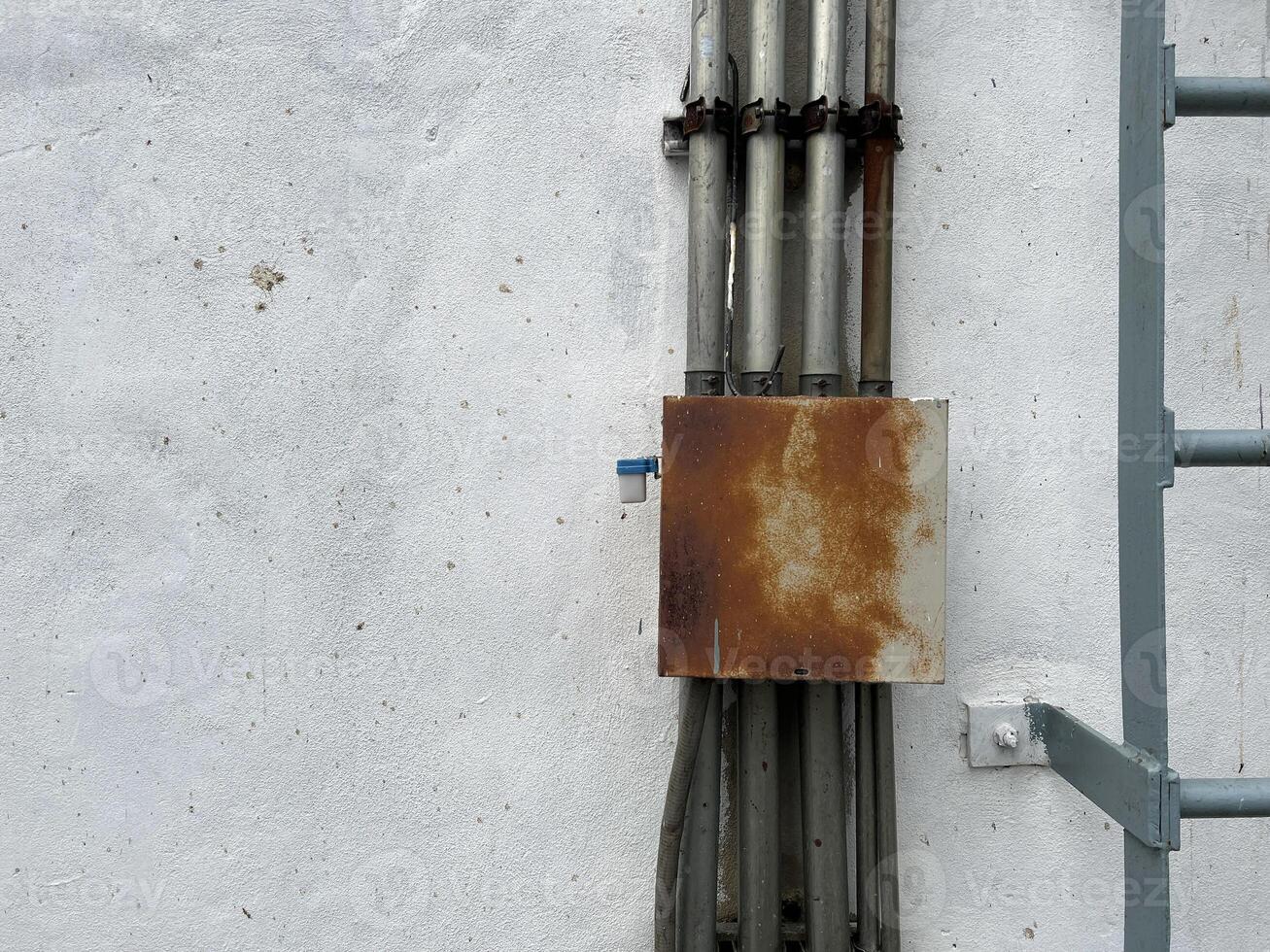 old metal pipe with a white wall photo