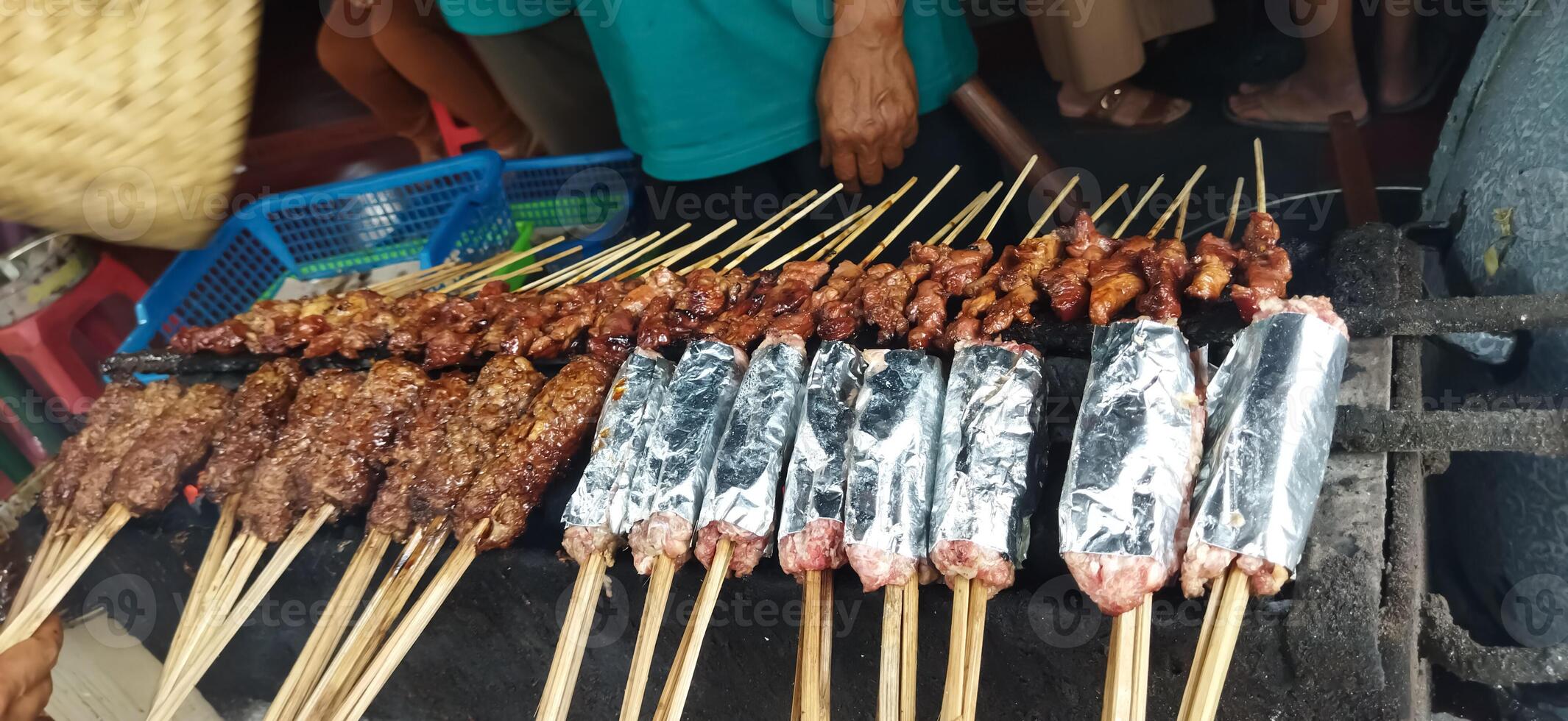 Defocused of Sate Buntel or Satay Buntel is satay made from minced mutton wrapped in mutton fat is being grilled on charcoal photo