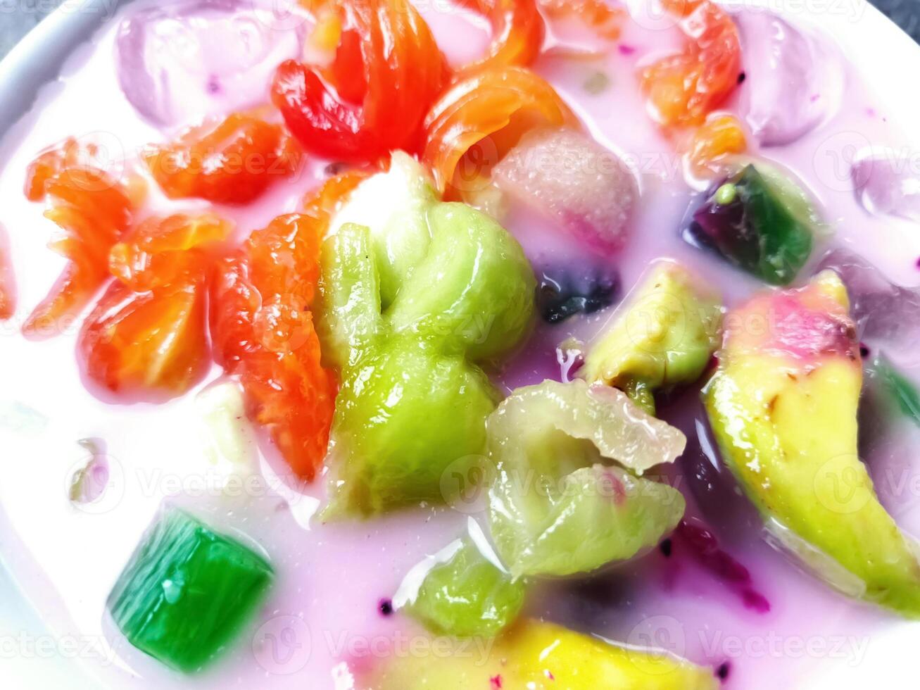Es buah or sop buah-is an Indonesian iced fruit cocktail dessert. This cold and sweet beverage is made of diced fruits mixed with shaved ice or ice cubes, and sweetened with liquid sugar or syrup. photo