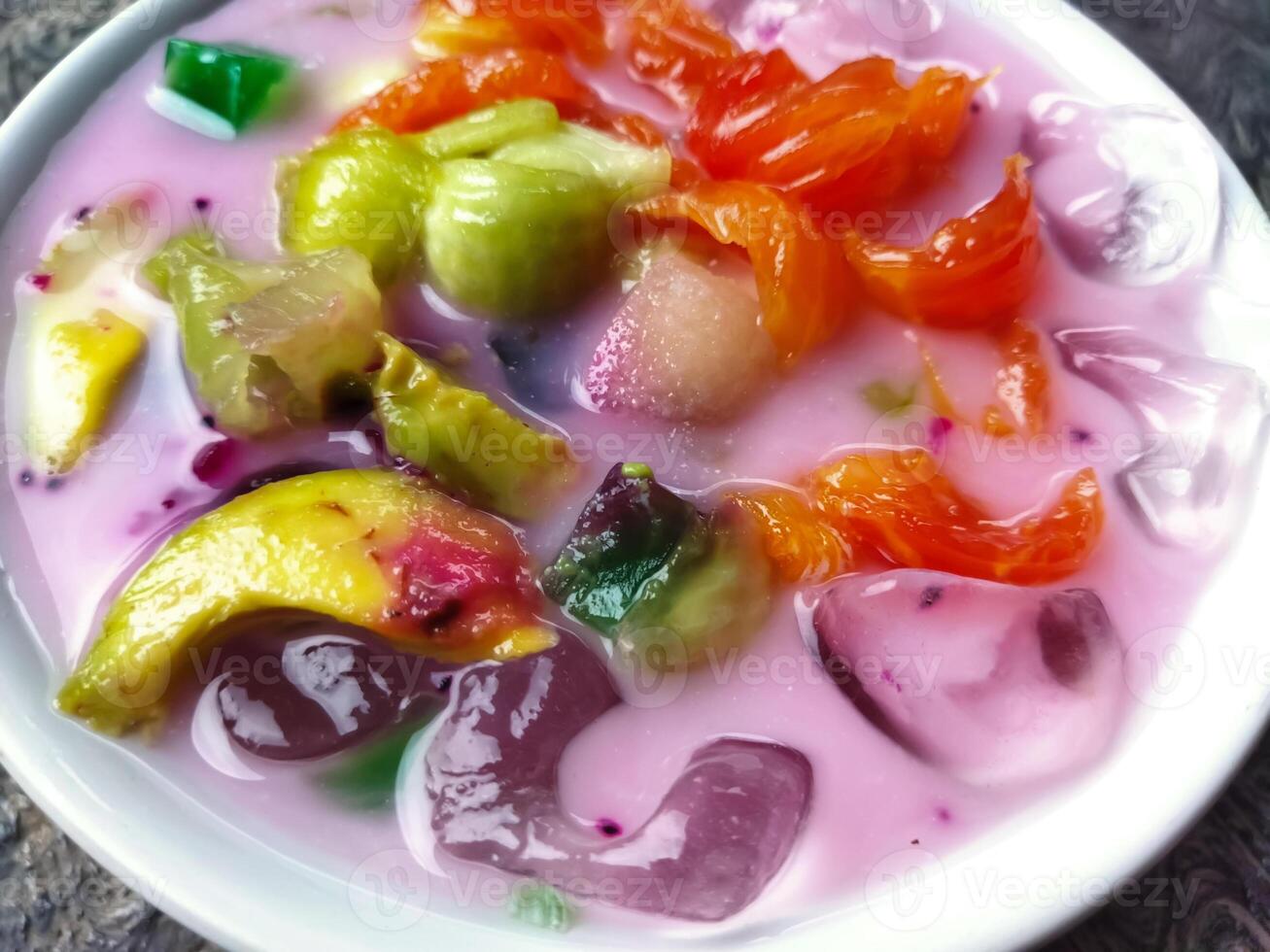 Es buah or sop buah-is an Indonesian iced fruit cocktail dessert. This cold and sweet beverage is made of diced fruits mixed with shaved ice or ice cubes, and sweetened with liquid sugar or syrup. photo