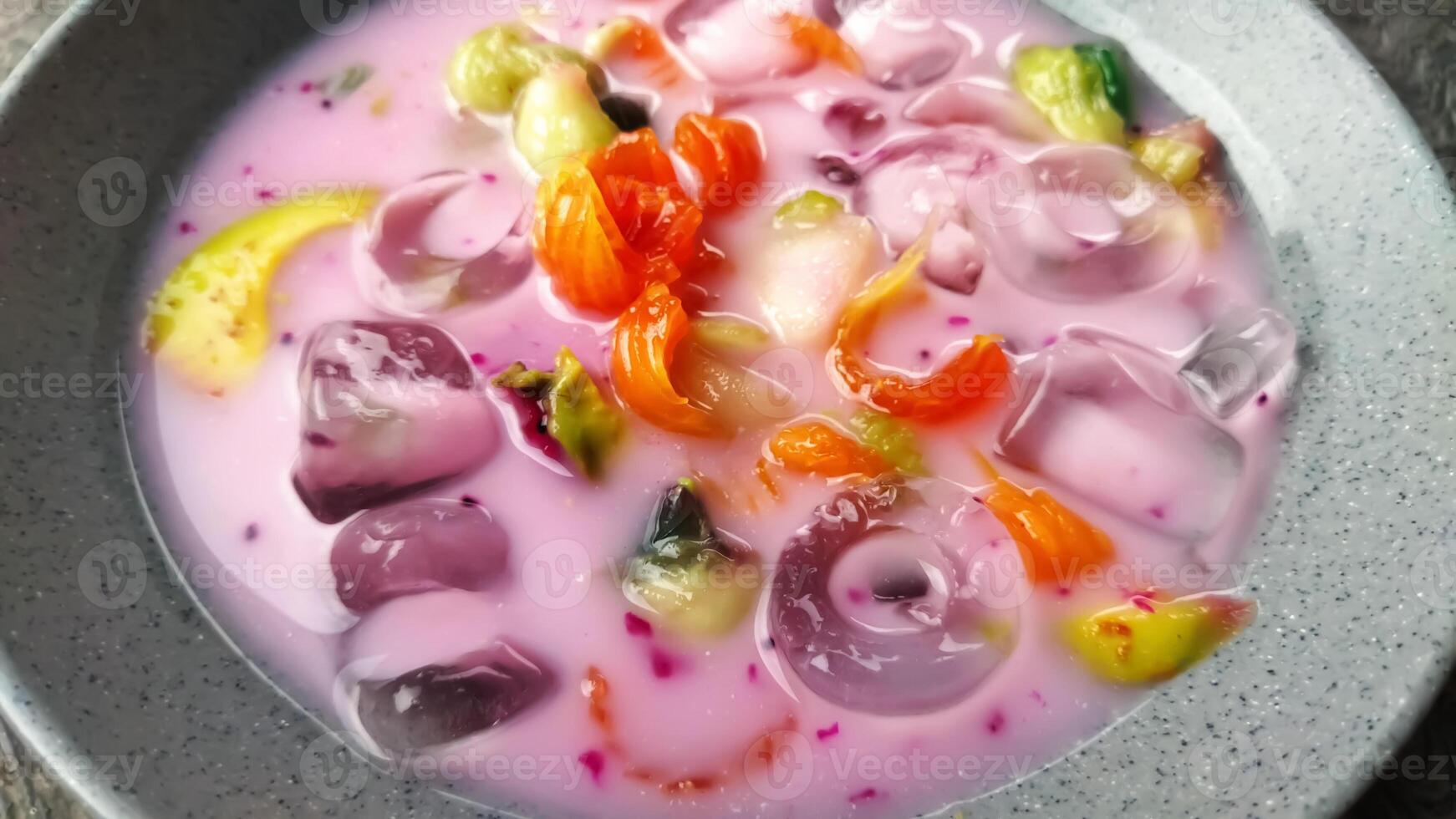 Es buah or sop buah-is an Indonesian iced fruit cocktail dessert. This cold and sweet beverage is made of diced fruits mixed with shaved ice or ice cubes, and sweetened with liquid sugar or syrup. photo