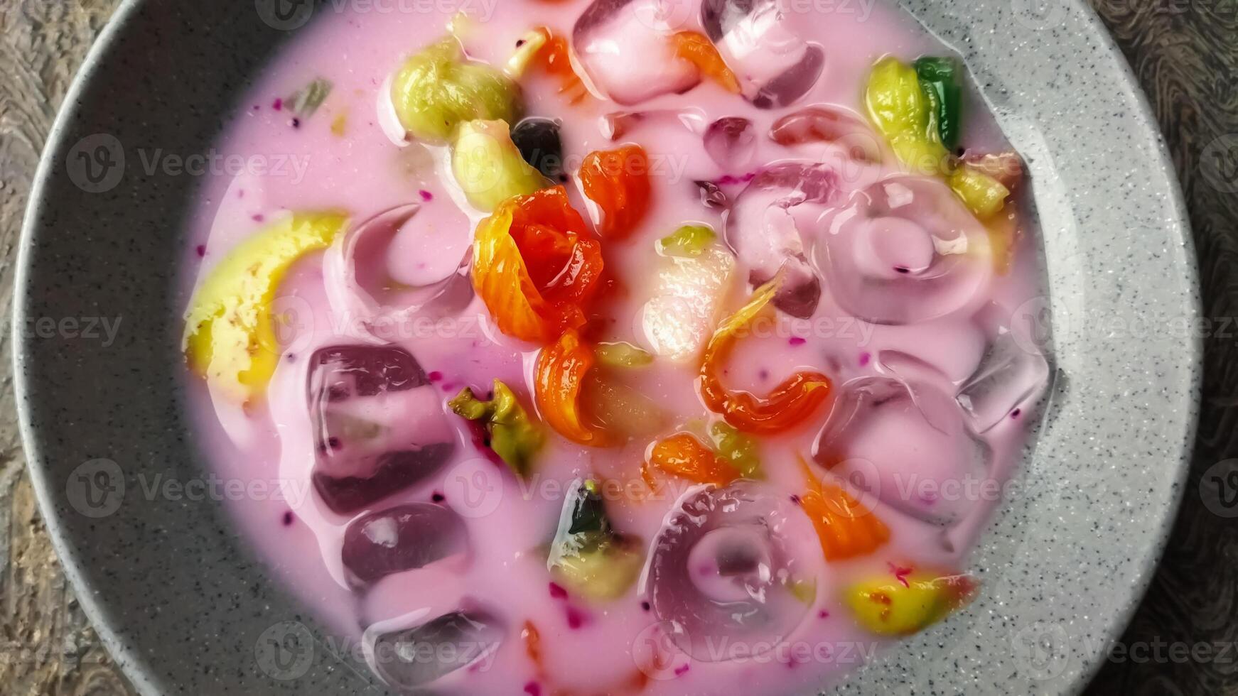 Es buah or sop buah-is an Indonesian iced fruit cocktail dessert. This cold and sweet beverage is made of diced fruits mixed with shaved ice or ice cubes, and sweetened with liquid sugar or syrup. photo