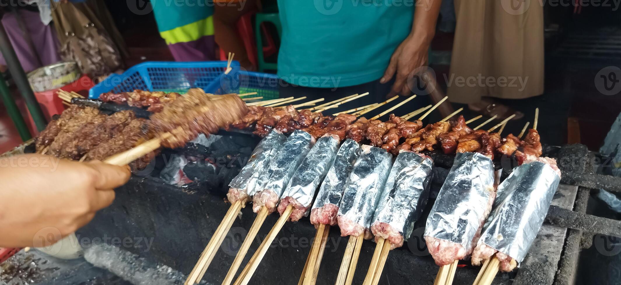 Defocused of Sate Buntel or Satay Buntel is satay made from minced mutton wrapped in mutton fat is being grilled on charcoal photo
