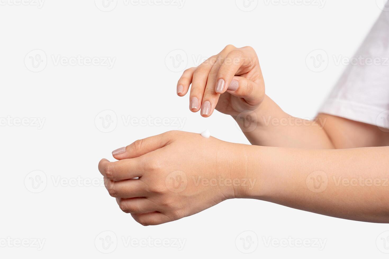 Female applying cream to her hands . photo