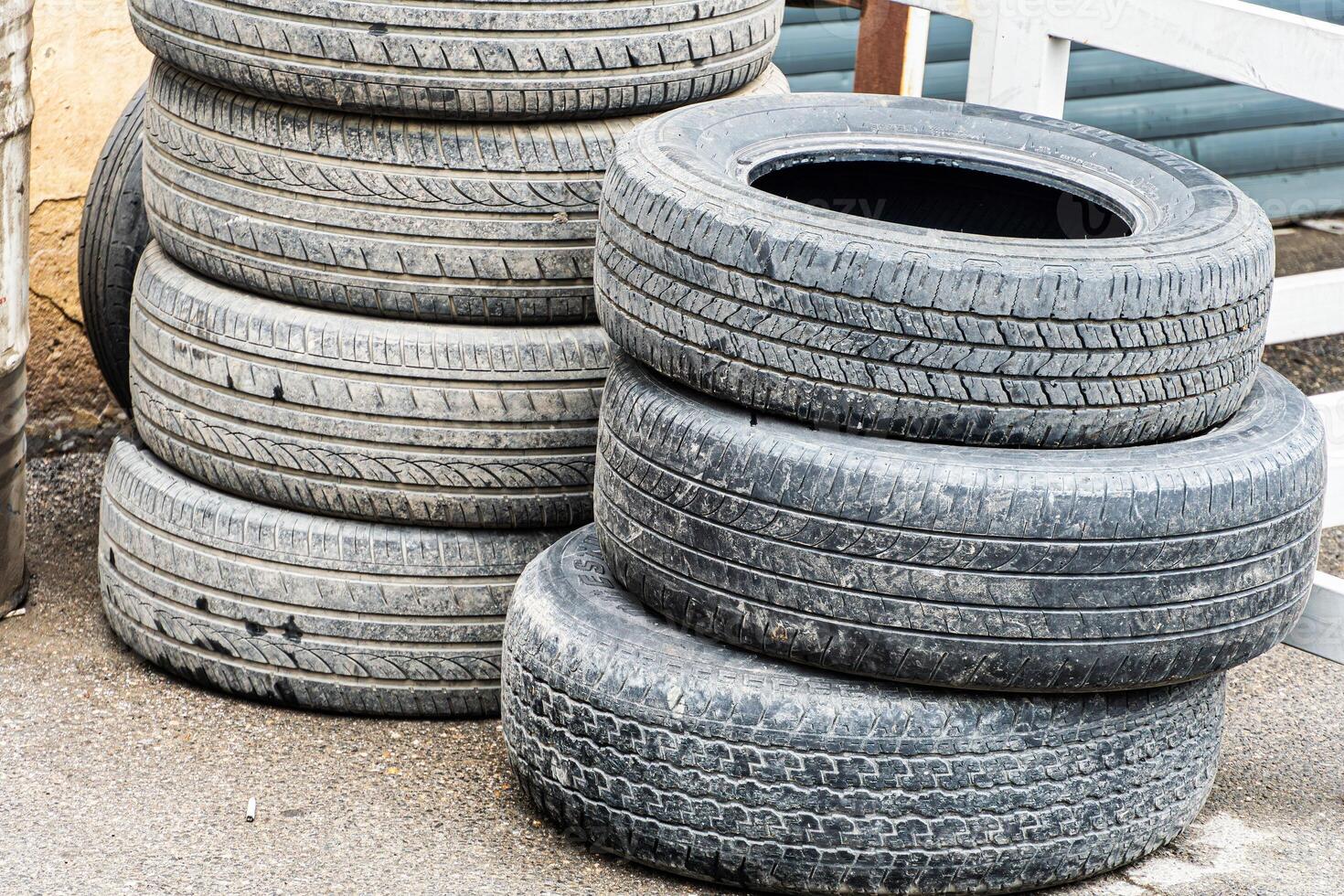 Stack of Worn Tires Outside photo