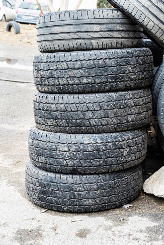 Stacked Tires on Asphalt photo