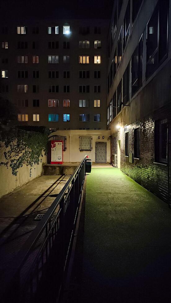 Prague, Czech republic - October 13, 2023. A red package pickup DPD box standing against a wall at night photo