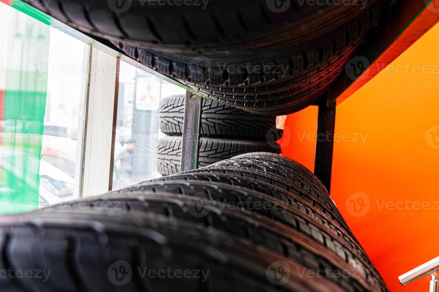 Stacked Tires in a Tire Shop Window photo