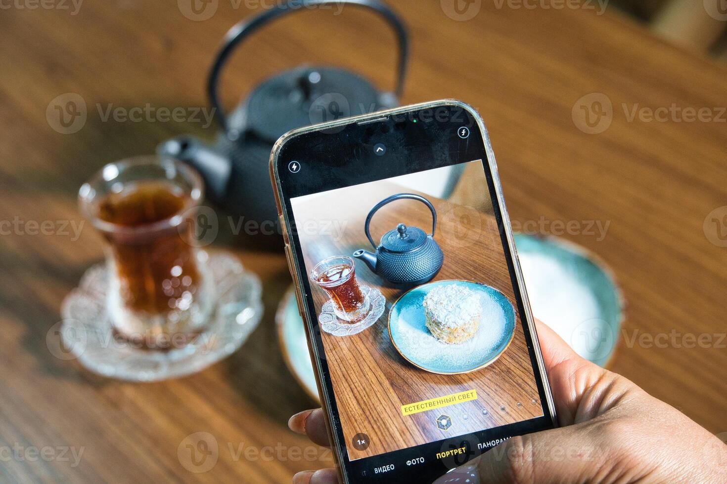 Smartphone Capturing Tea and Dessert photo