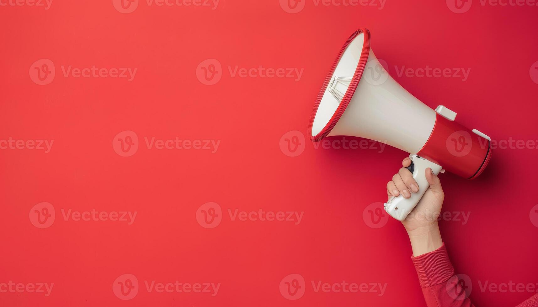Hand Holding Megaphone on Red Background with Copy Space for Text Banner photo