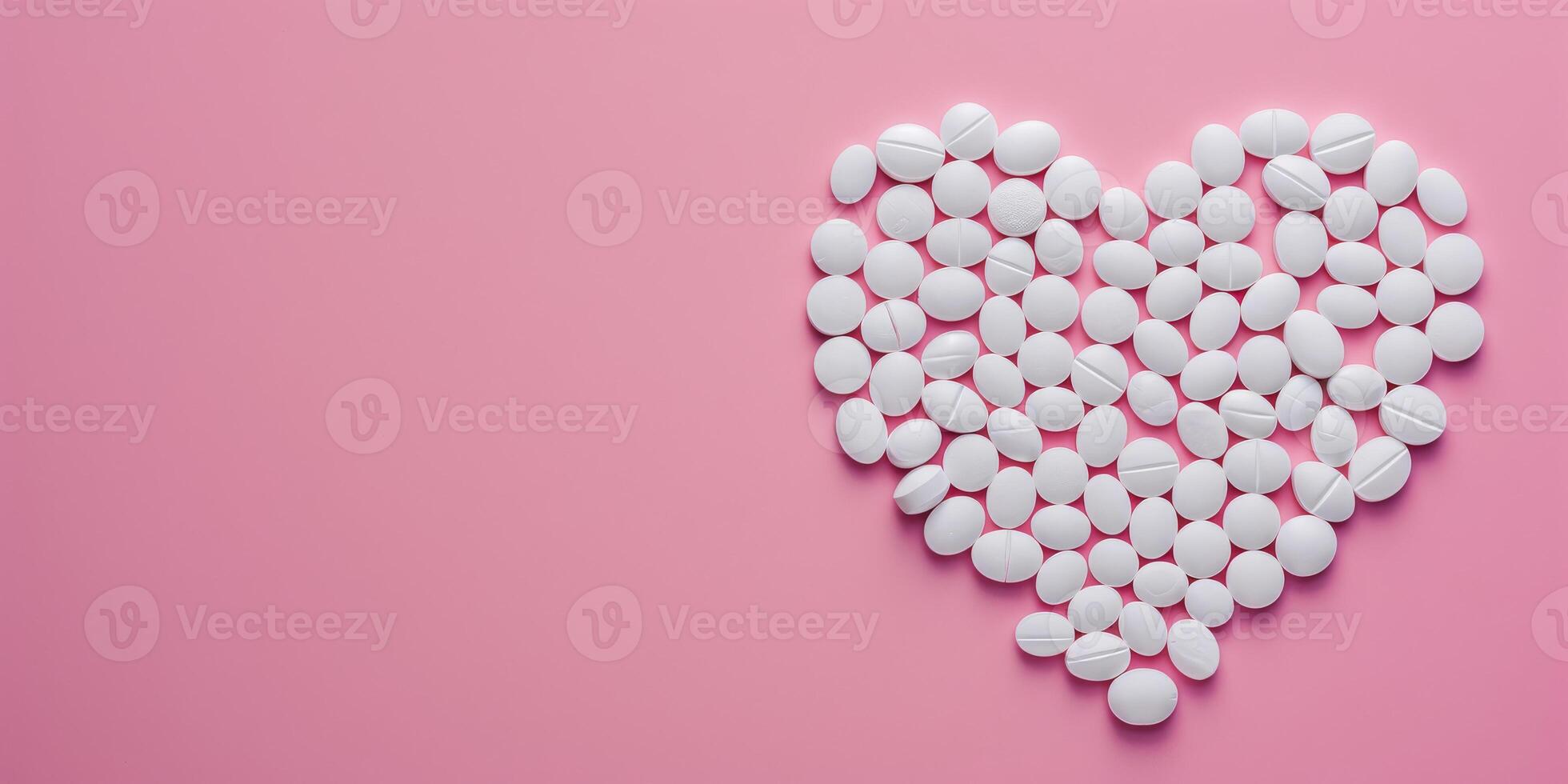 Top view of heard made from white pills on pink background, concept for medical health photo