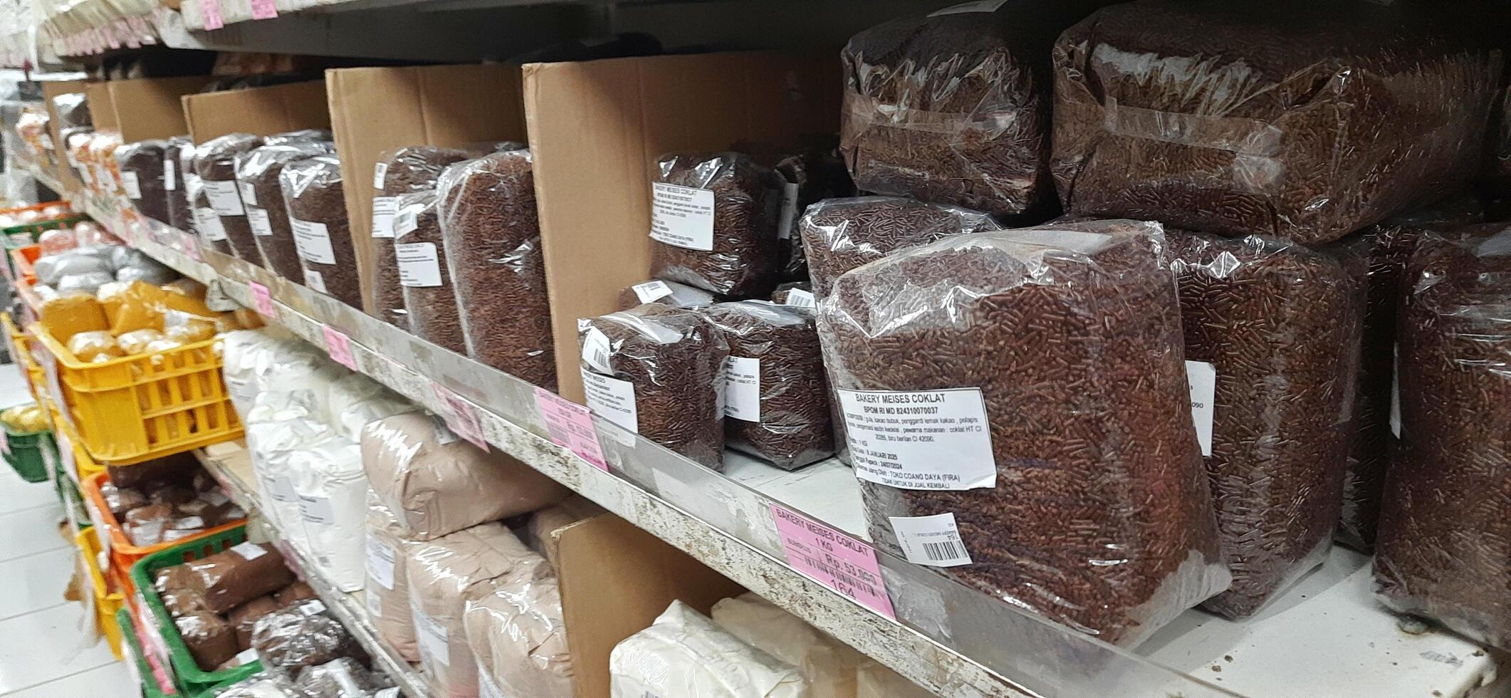 Coang supermarket shelf display. One of the complete cake and food equipment and ingredients stores in Makassar. South Sulawesi, Indonesia - August 7 2024 photo