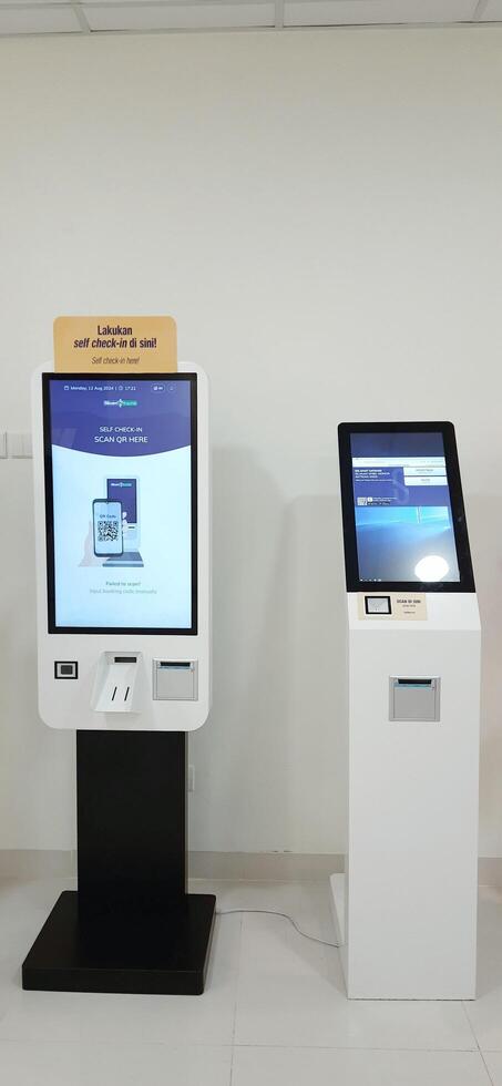 Modern self check in machine for patient registration in hospitals. Makassar, South Sulawesi, Indonesia - August 12 2024 photo
