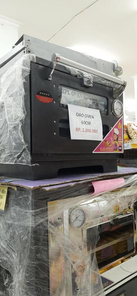 Coang supermarket shelf display. One of the complete cake and food equipment and ingredients stores in Makassar. South Sulawesi, Indonesia - August 7 2024 photo