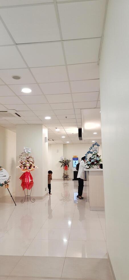 Atmosphere of patient queues to receive medical services at waiting area hospital. Makassar, South Sulawesi, Indonesia - August 12 2024 photo