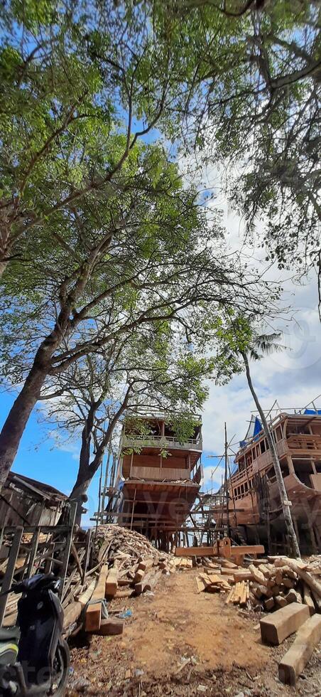 Manufacturing of construction traditional phinisi wooden boats bulukumba. South Sulawesi, Indonesia - July 29 2024 photo