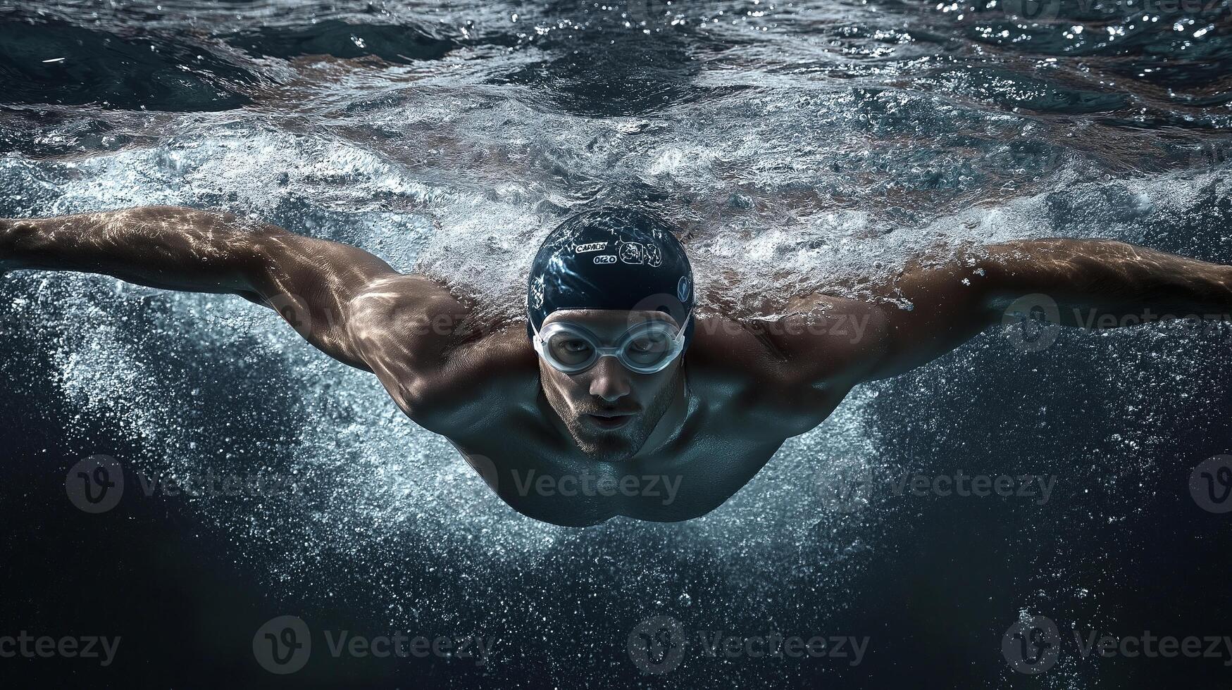 olympic swimmer in swimming goggles and swim cap front view in water photo