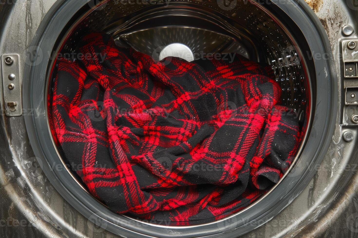 Red And Black Plaid Shirt Inside Open Washing Machine, Laundry Day Chores And Housekeeping Concept photo