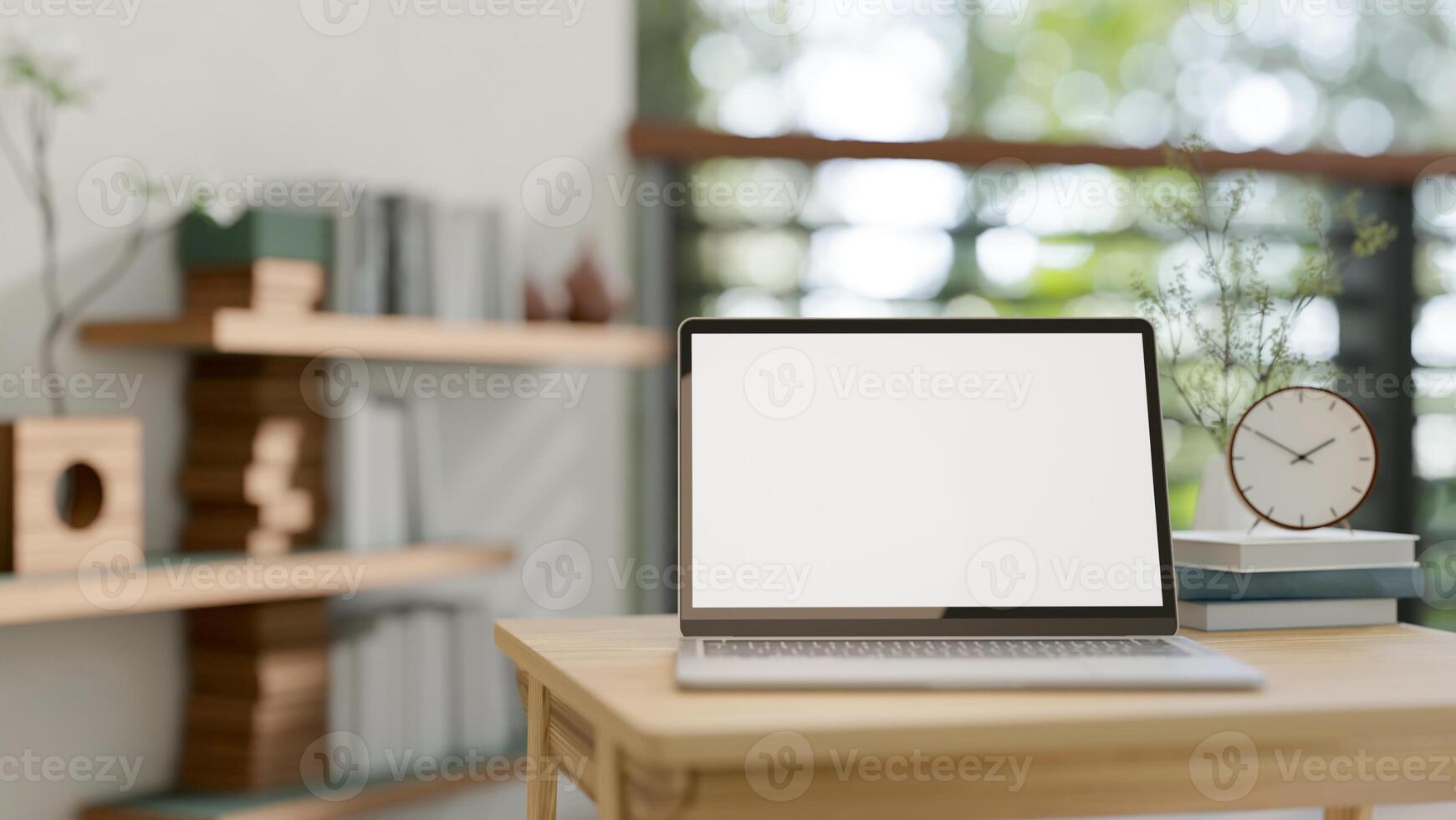 A close-up image of a laptop with a white-screen mockup on a wooden table in a room at home. photo