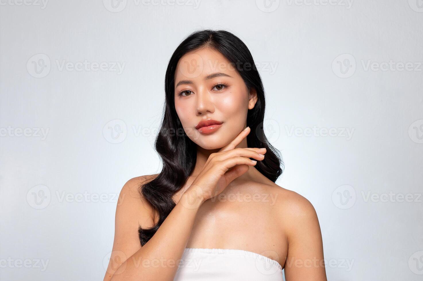 A young Asian woman with perfect beauty face, long hair, and healthy tanned skin portrait. photo