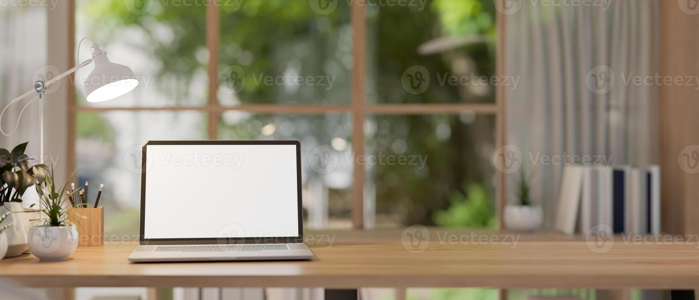A laptop computer mockup on a wooden table in a contemporary, simple room. photo