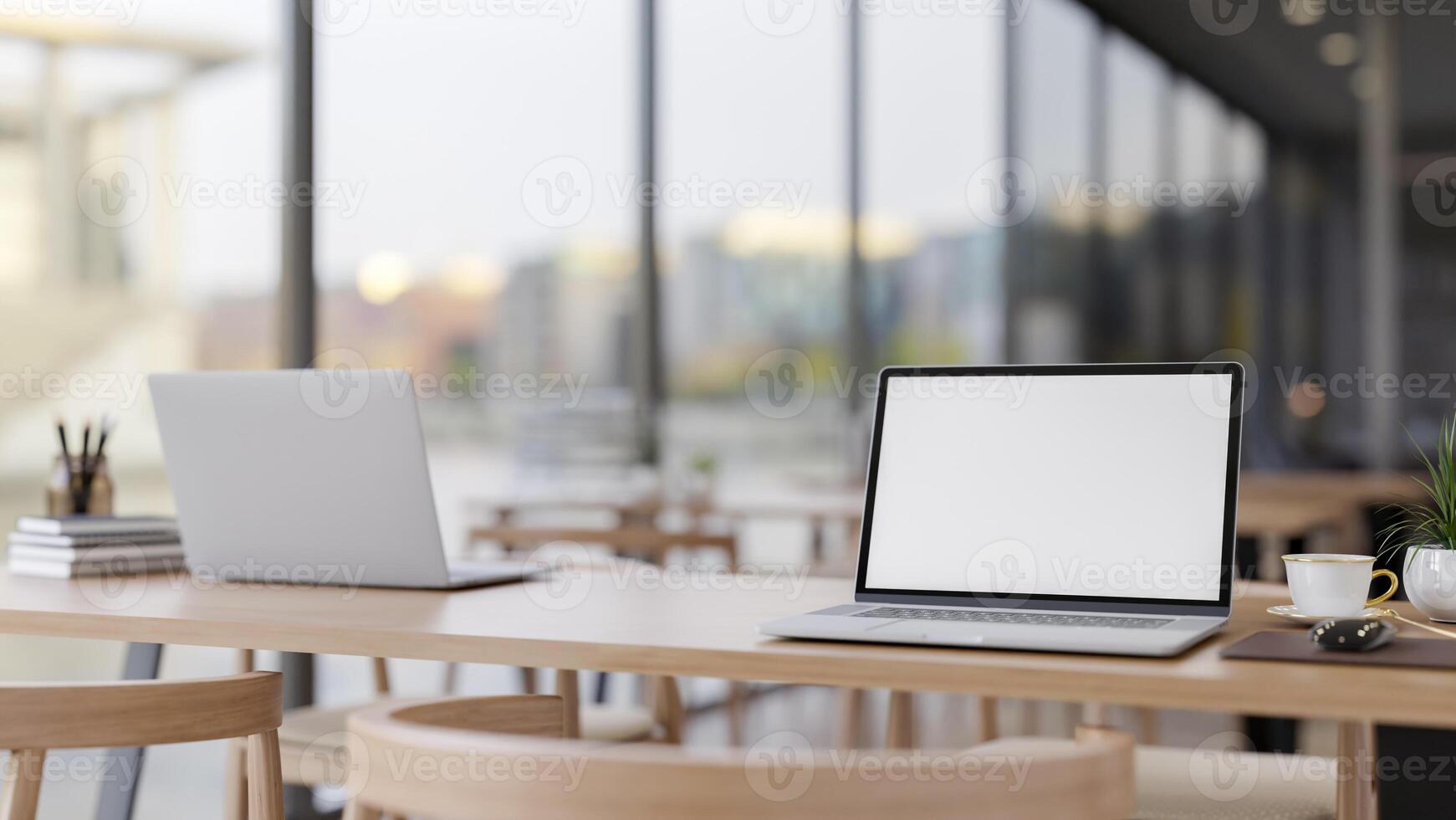 A laptop on a wooden table by the window, in a minimal contemporary coffee shop co-working space. photo