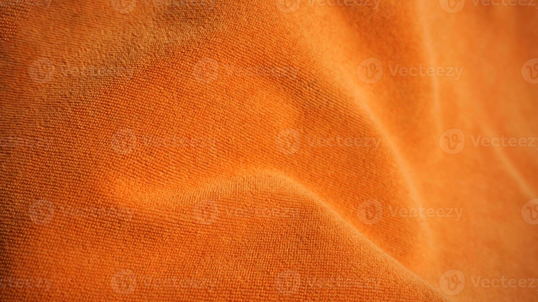Detail of orange towel fabric texture background with copy space. photo