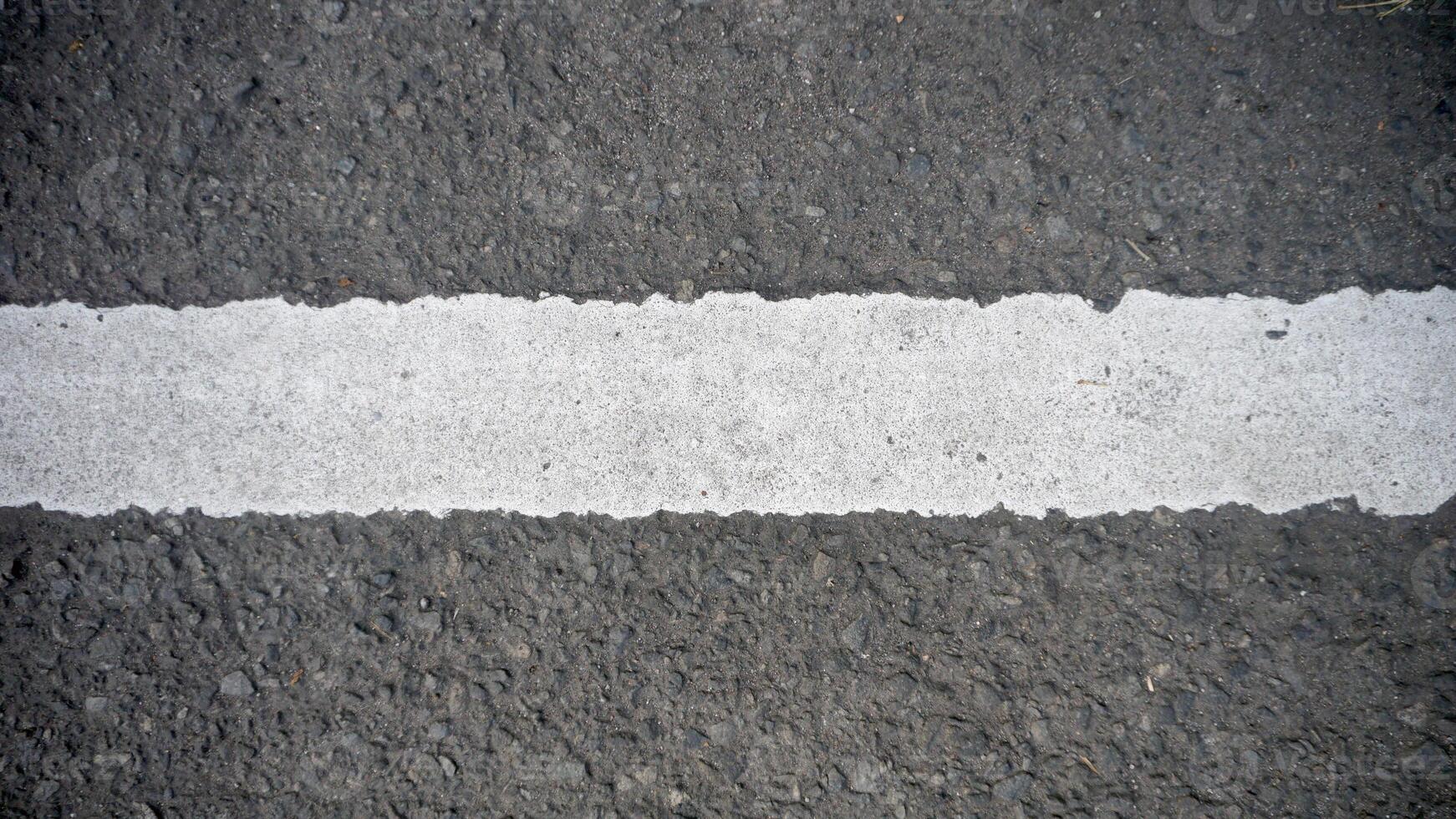 White line on the asphalt road. Abstract background or texture for design. photo