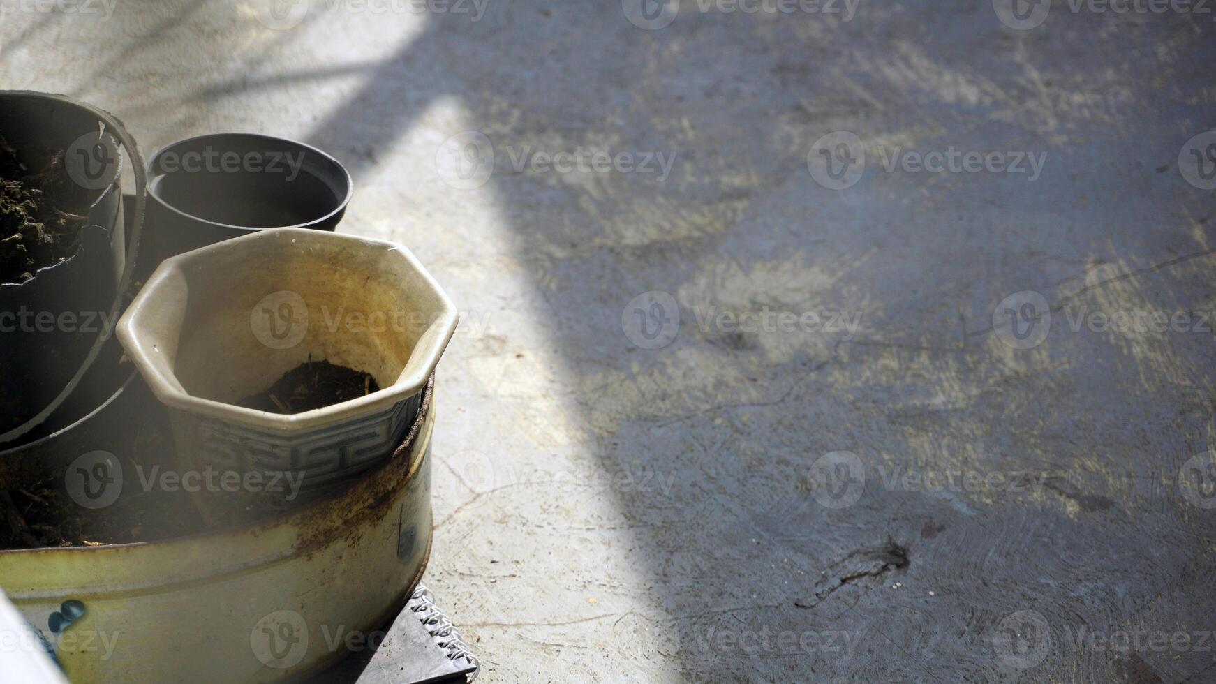 Empty pots for planting seedlings on the cement floor, house yard background with. photo