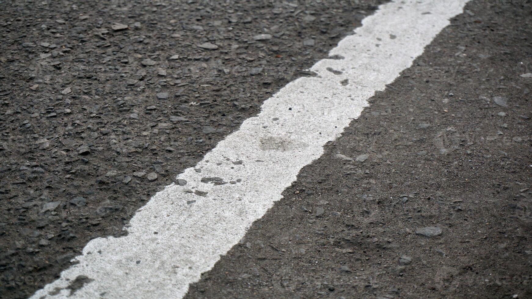 White line on the asphalt road. Abstract background and texture for design. photo