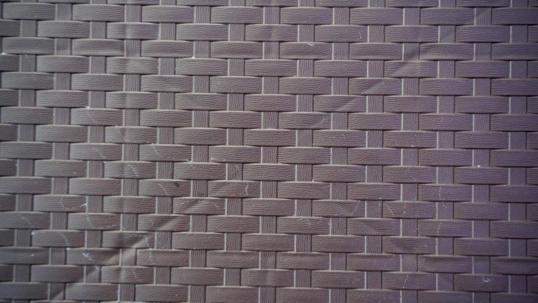 Brick wall texture background. Brown flat pattern of synthetic rattan material made from plastic. photo