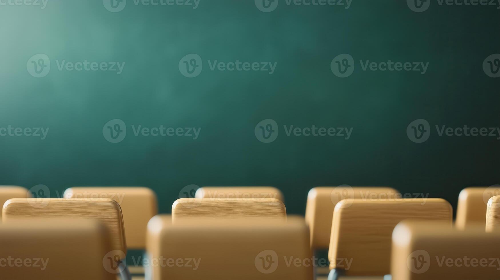 Empty classroom with wooden desks ready for students, featuring a green chalkboard in the background. photo