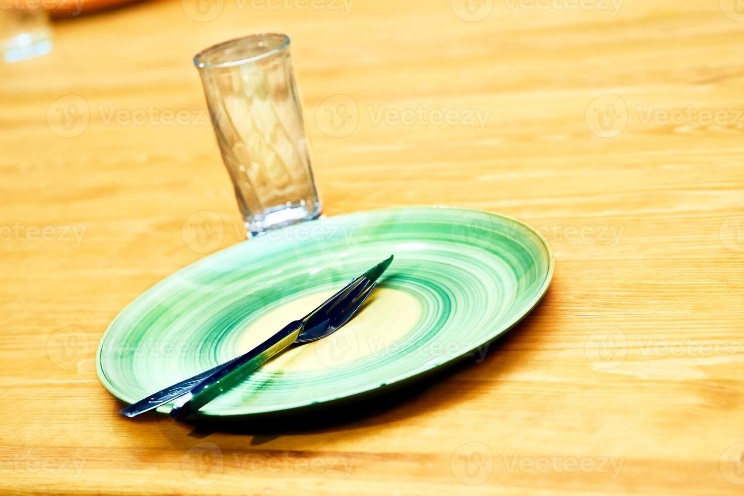 Grunge green plate with fork,knife,glass photo
