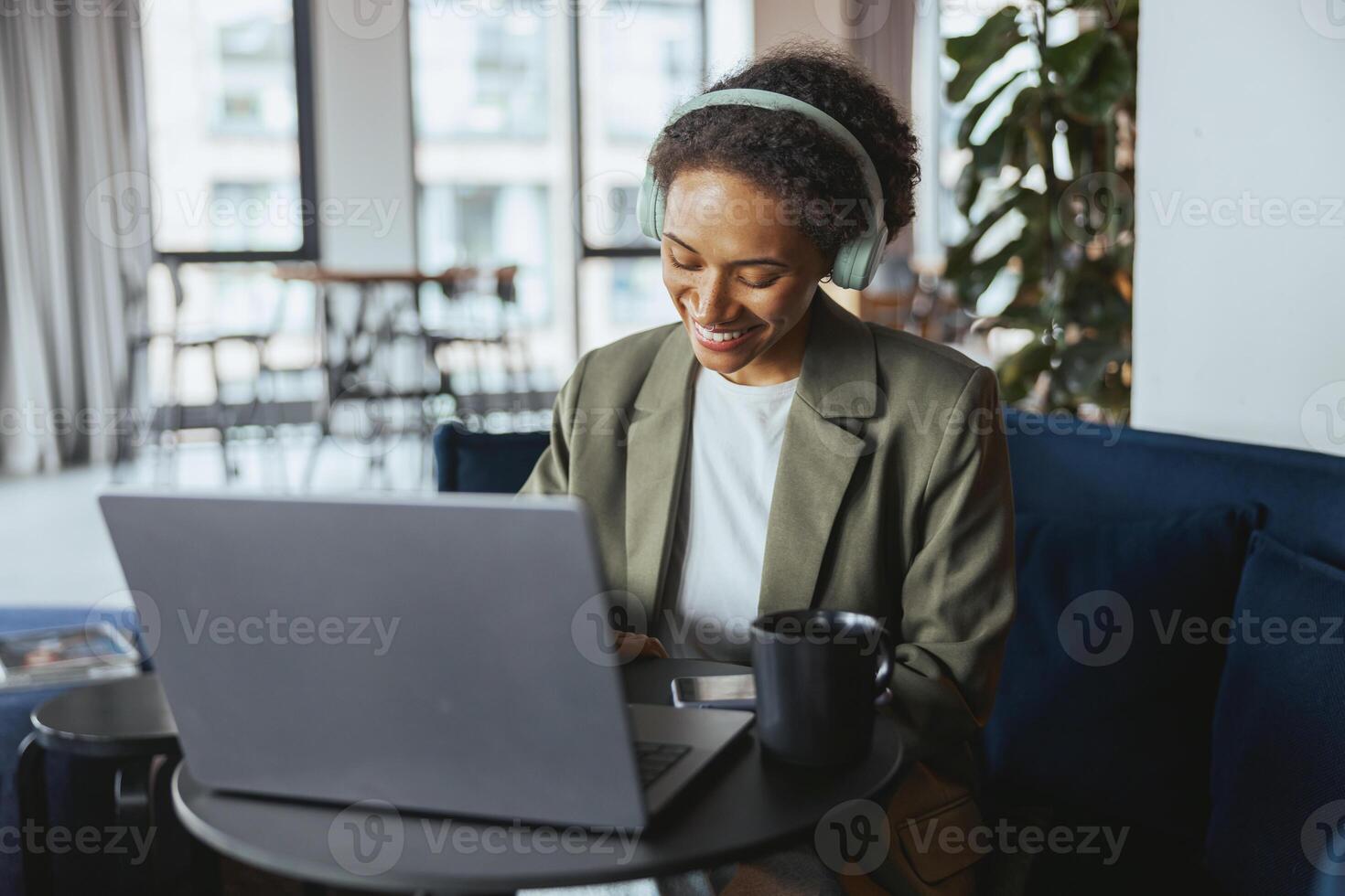 Whitecollar worker at a formal event sitting in a room using a laptop computer photo