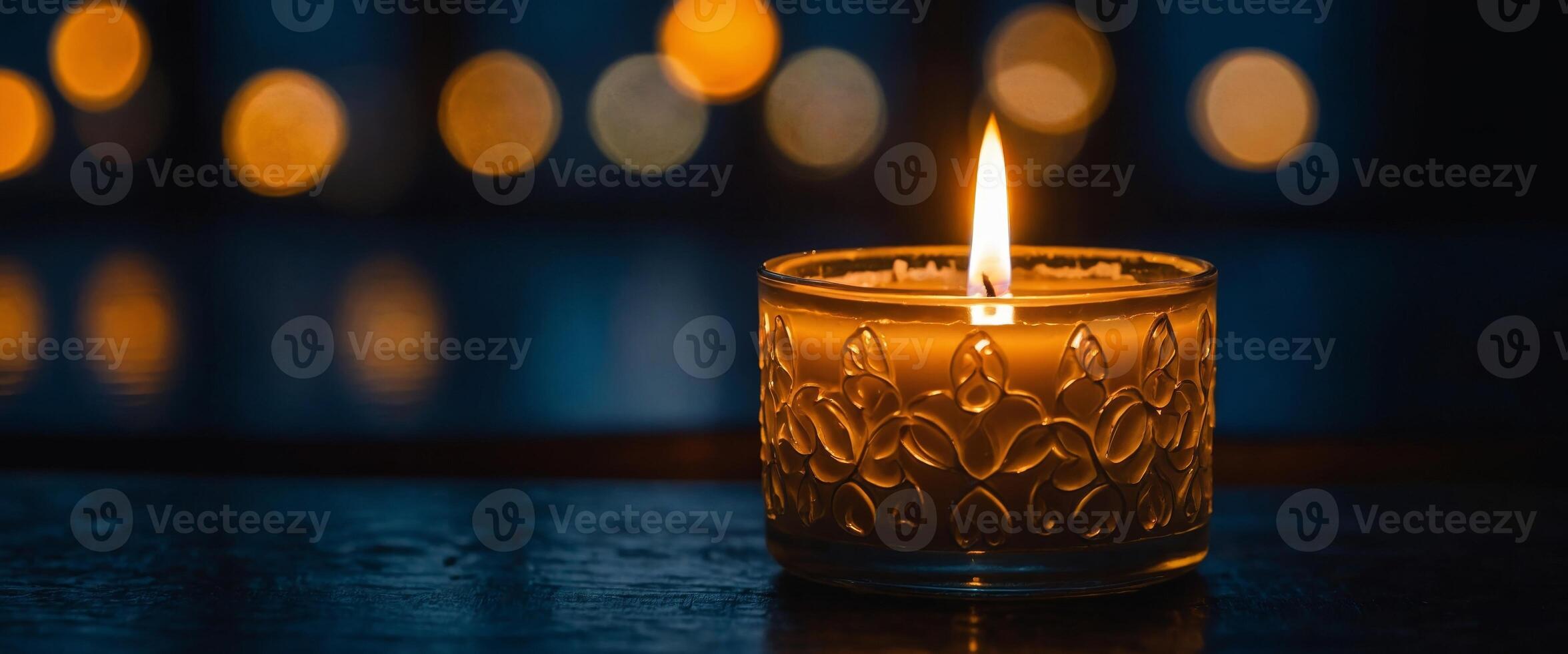 A candle burns on a dark table, symbolizing peace. photo