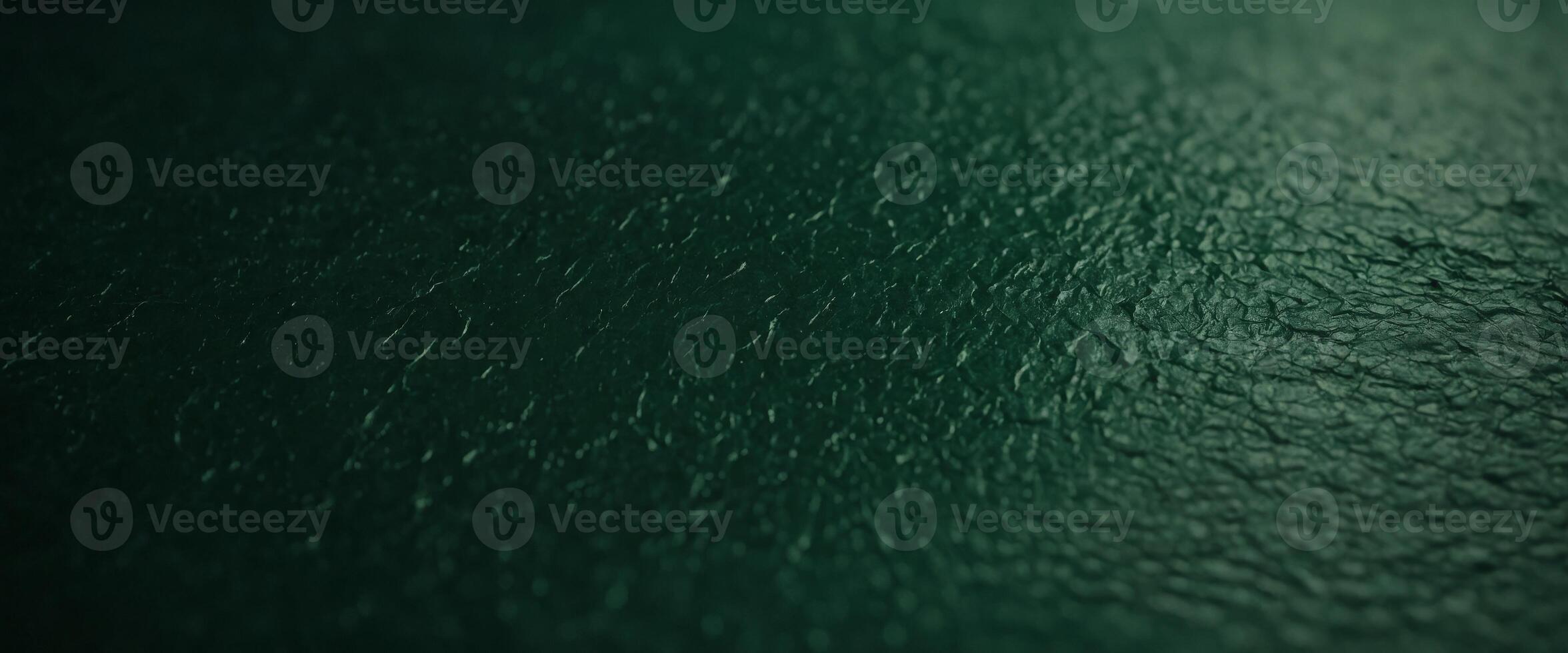 A green paper texture background offers an abstract dark green surface suitable for various design projects. photo