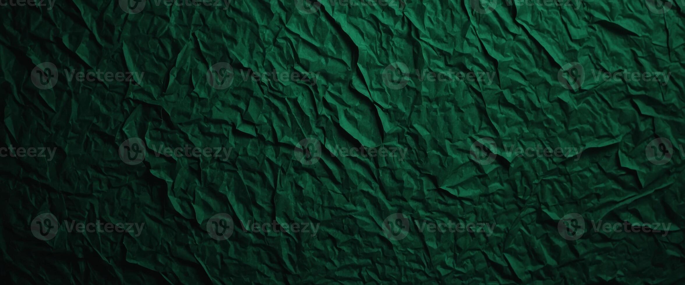 A green paper texture background offers an abstract dark green surface suitable for various design projects. photo