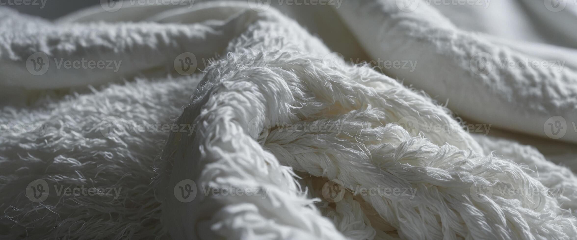 A texture of a white towel suitable for backgrounds This fabric or textile is made of cotton fiber material, giving it a plush, fluffy, dry, soft, and clean appearance. photo