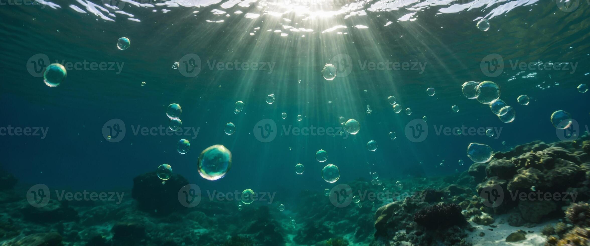 Bubbles and bokeh underwater in clear green ocean of California. photo