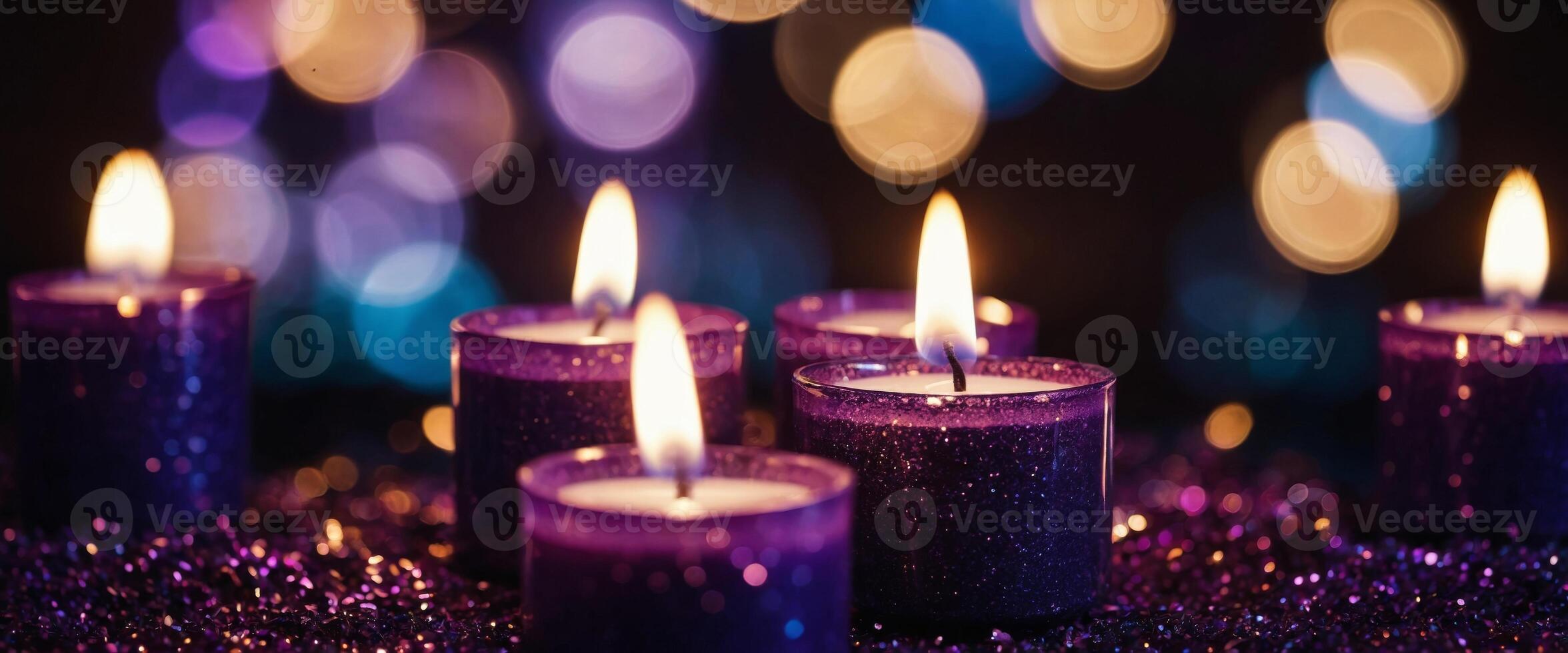 Candles adorned with purple glitter burn in the darkness, surrounded by blurred, abstract lights. photo