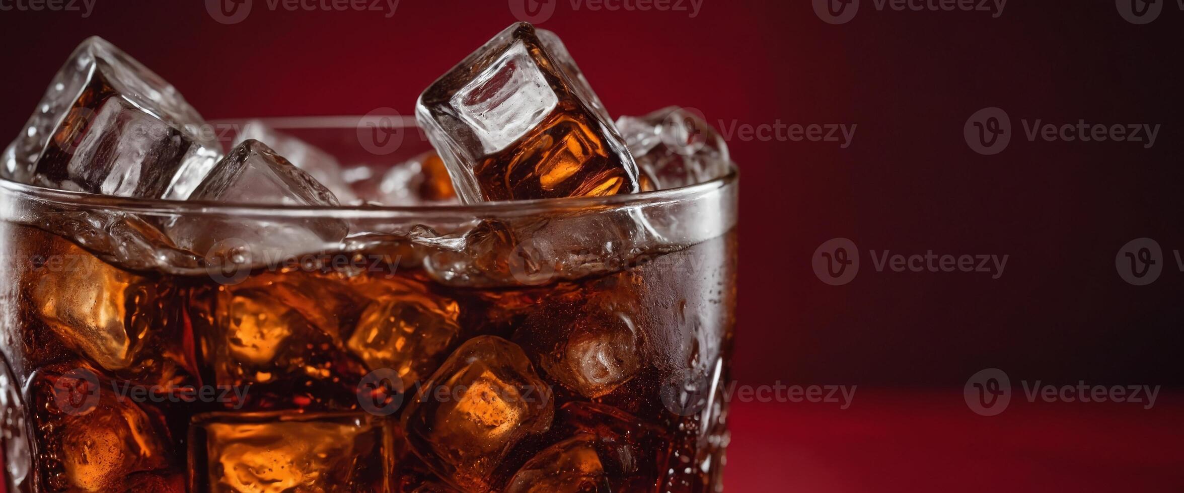 Cola with ice Fresh cold sweet drink with ice cubes Over red background with copy space. photo