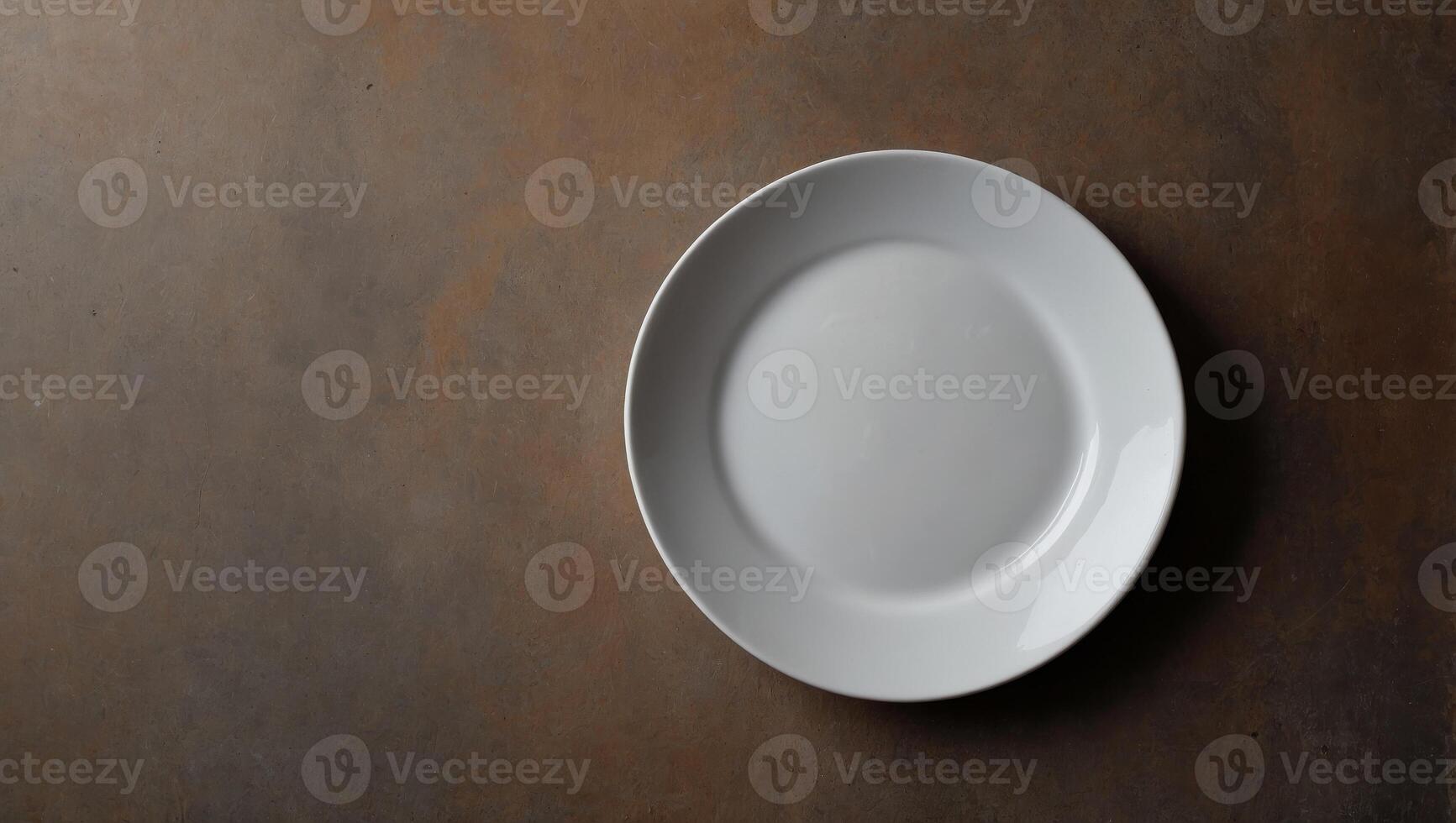 Empty white ceramic plate on brown concrete background Top view, copy space for food or other objects. photo