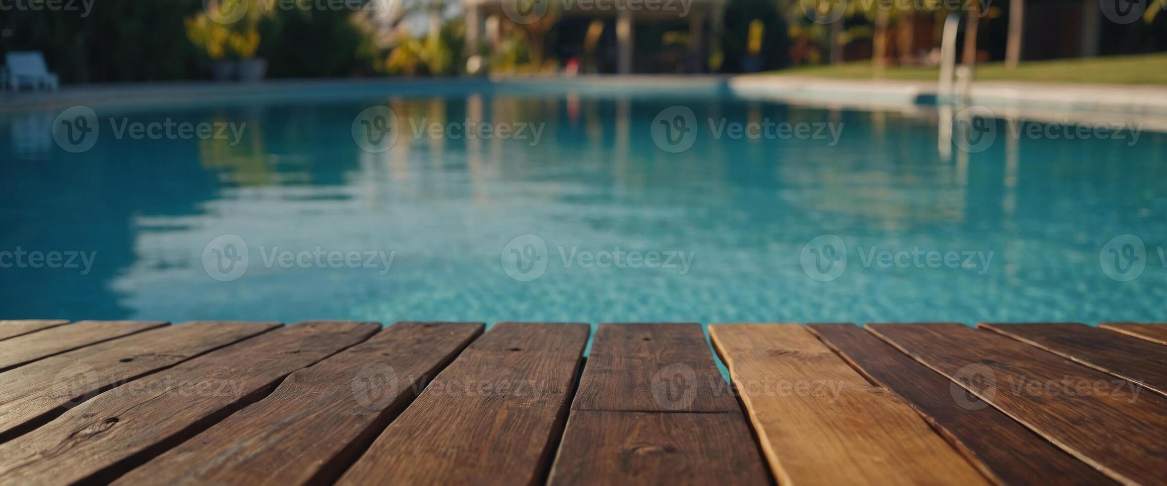Empty wooden table in front with blurred background of swimming pool. photo
