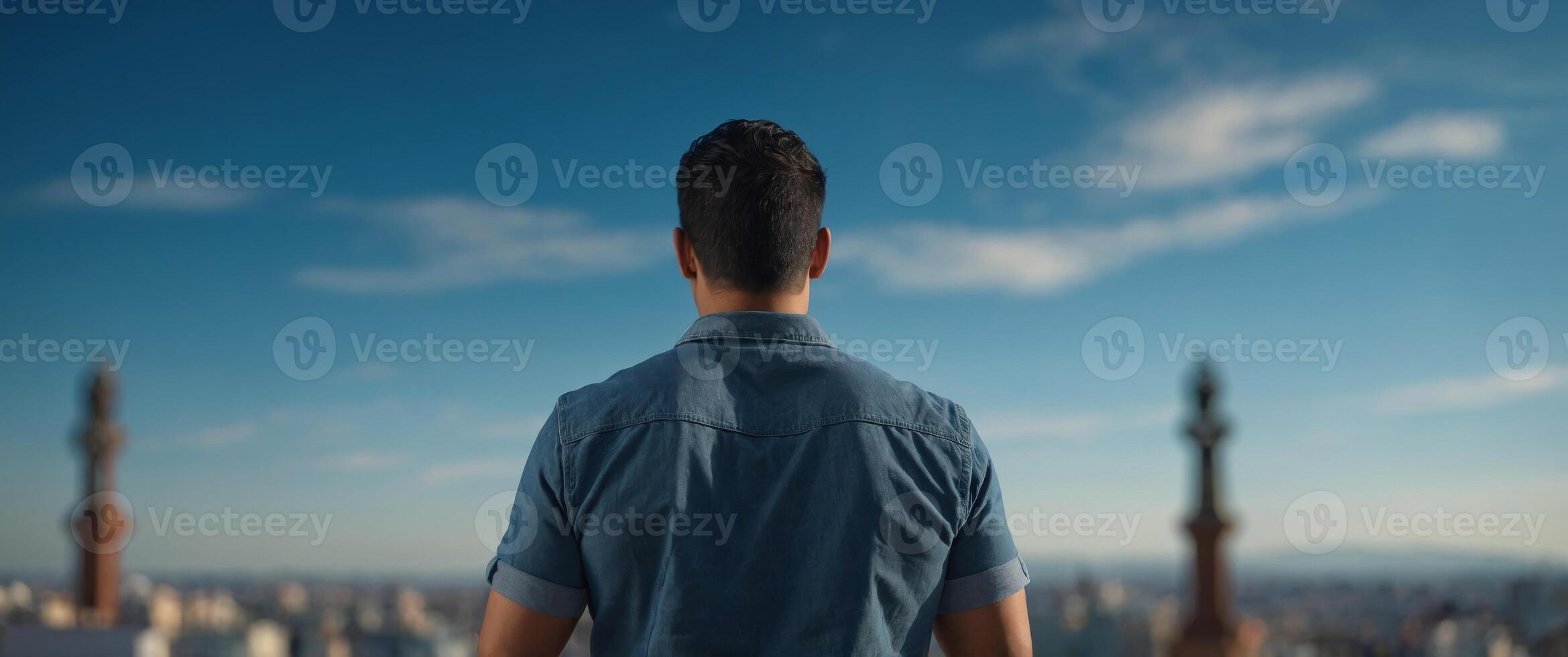 Handsome hispanic man standing over blue background standing backwards looking away with arms on body. photo