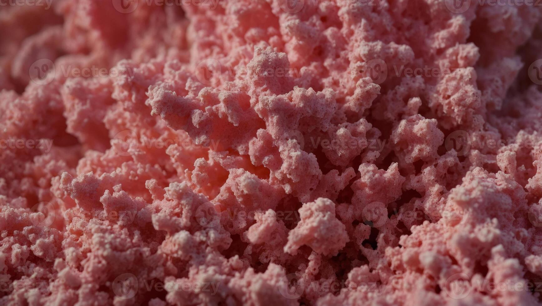 Texture of a porous pink sponge close up Cellulose pink sponge micro plastic made from foam. photo