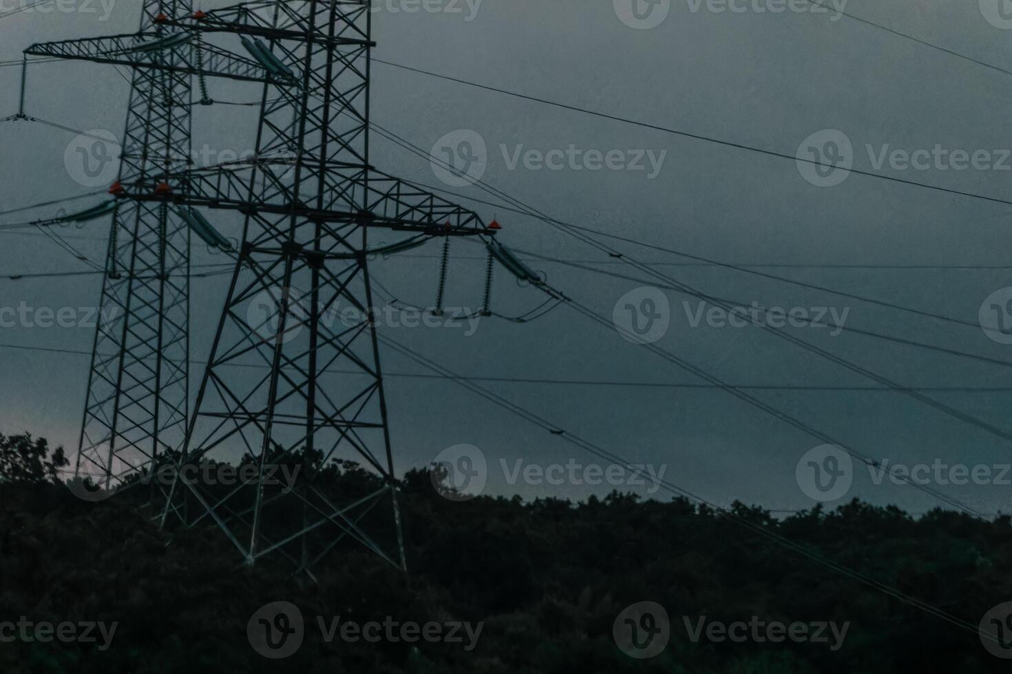 High voltage electric distribution network at sunset. Power transmission lines on supports with ceramic insulators and transformers at large electrical distribution substation photo