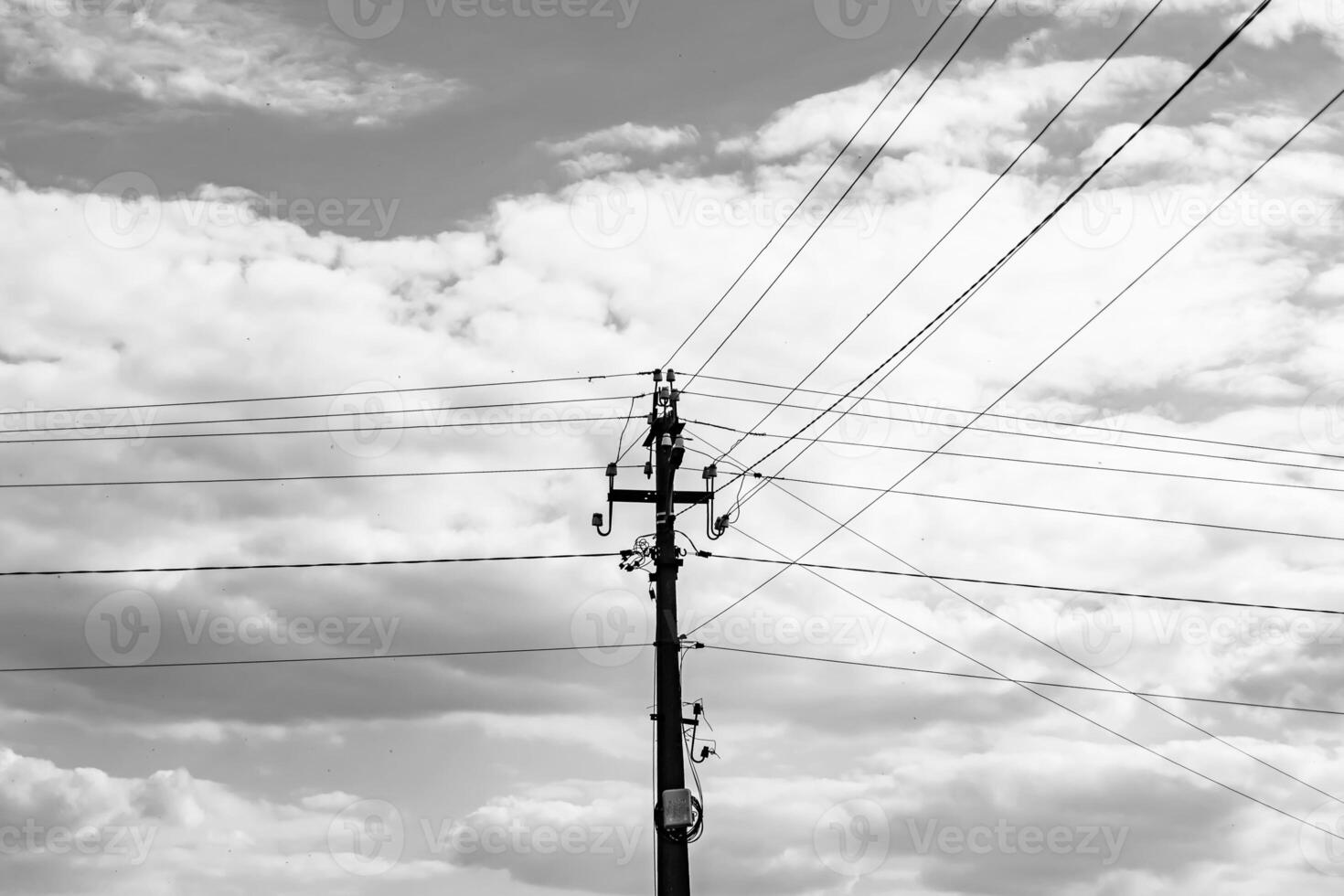 Power electric pole with line wire on dark background close up photo