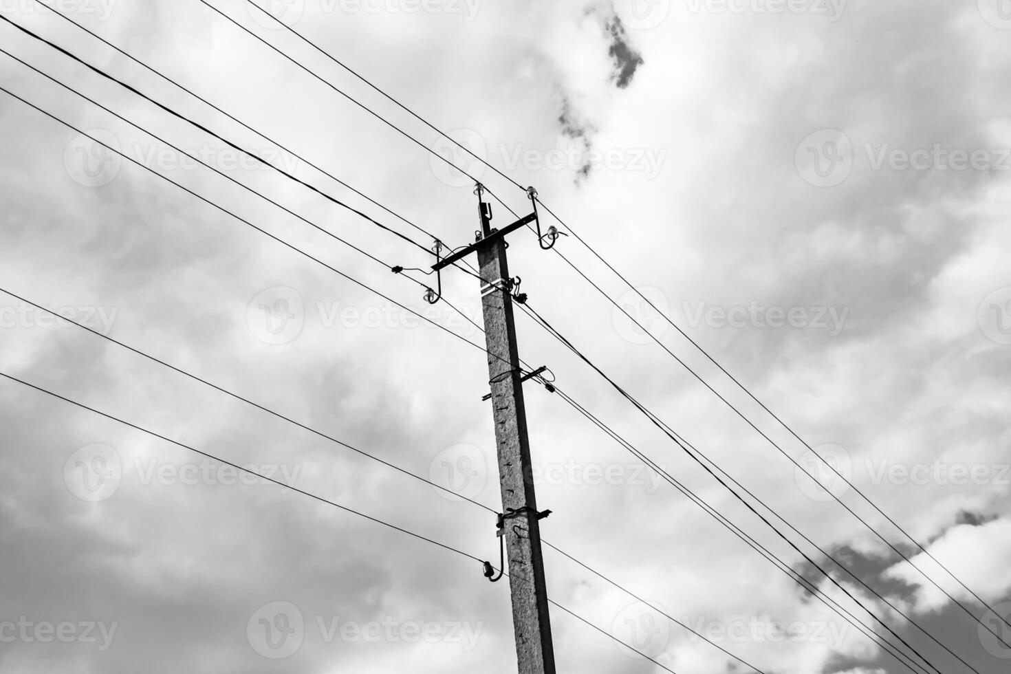 Power electric pole with line wire on dark background close up photo